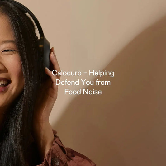 Smiling woman wearing headphones to block ‘food noise,’ illustrating Calocurb’s natural appetite-suppression aid