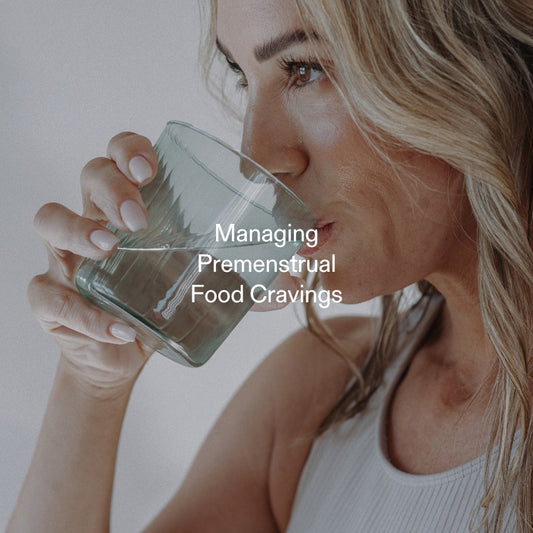 Woman drinking water to manage premenstrual food cravings with natural GLP-1 support